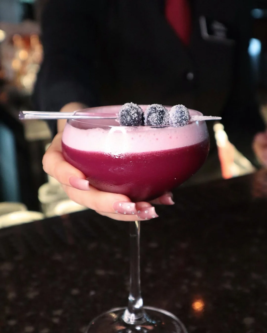 A blackberry coupe cocktail with sugared berries, served at the Prime 88 bar